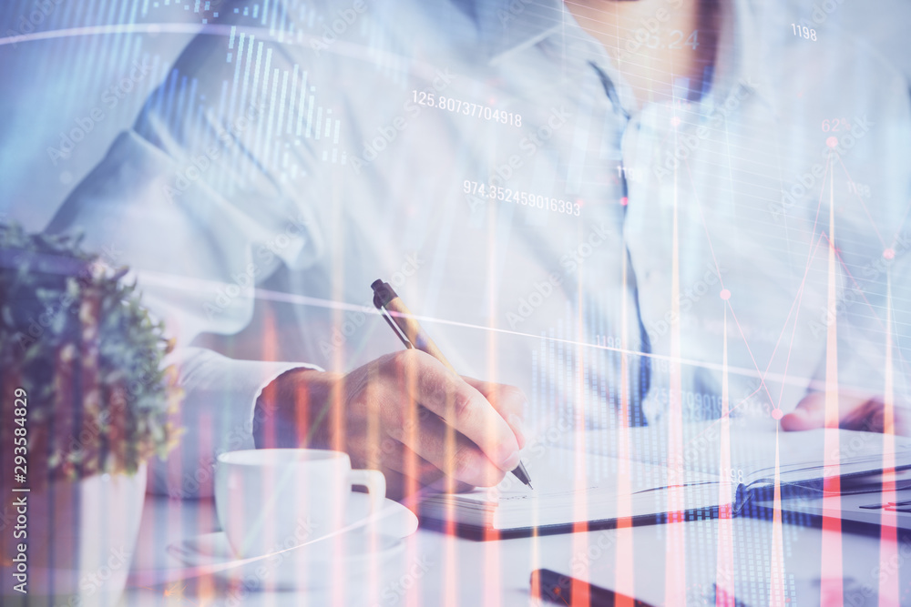 Double exposure of man's hands writing notes of stock market with forex chart. Double exposure of man's hands writing notes of stock market with forex chart.
