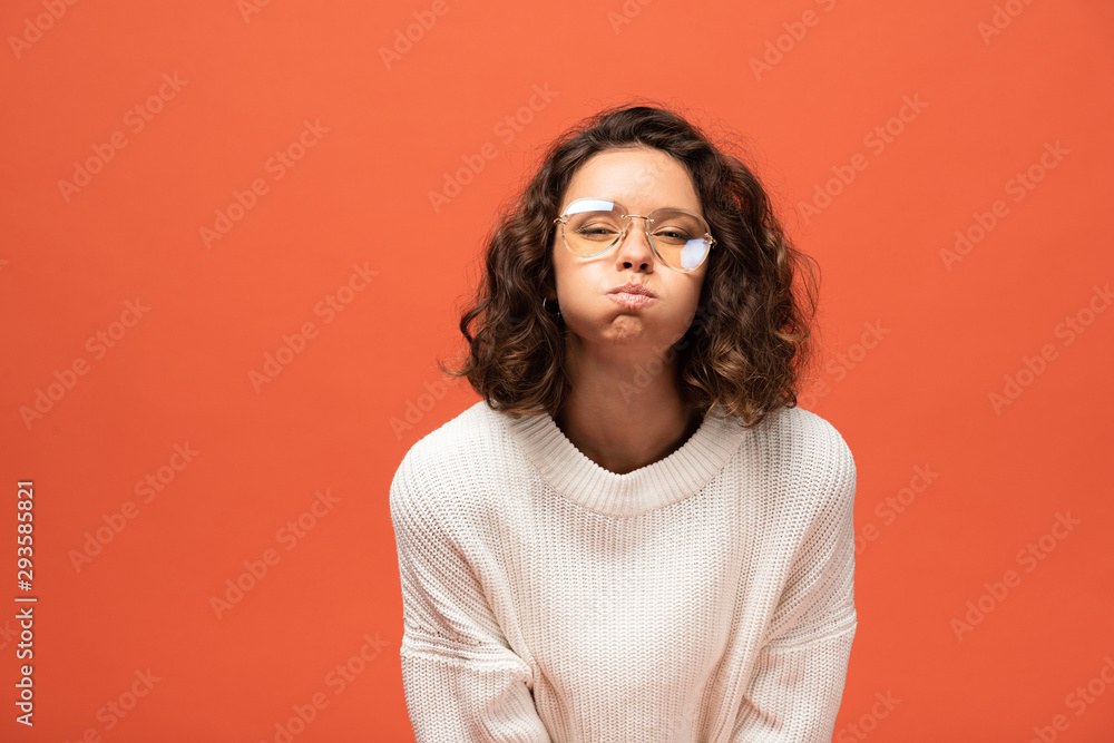 funny woman in autumnal outfit and glasses blowing cheeks isolated on orange funny woman in autumnal outfit and glasses blowing cheeks isolated on orange