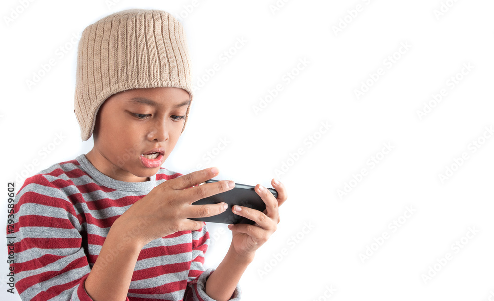 Little asian boy in wool hat using smart phone on white background Little asian boy in wool hat using smart phone on white background
