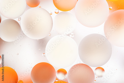 bright oily drops in water with colorful background, close-up 