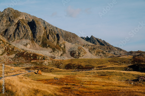 Beautiful alpine view at sunset, mountain peaks. Col de la Lombarde or Colle della Lombarda high pass in the Alps on the border between France and Italy photo