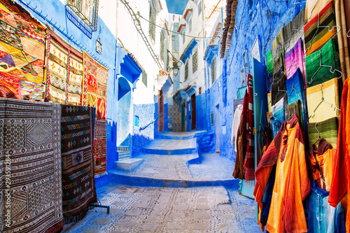 Traditional carpets on the blue Chefchaouen street. © lizavetta
