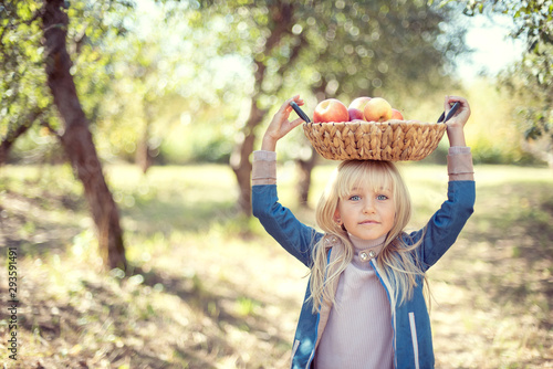 Children with Apple in Orchard. Harvest Concept.