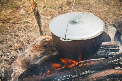 Closed cauldron boiling on a campfire
