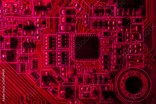 Red themed circuit board with chip close-up