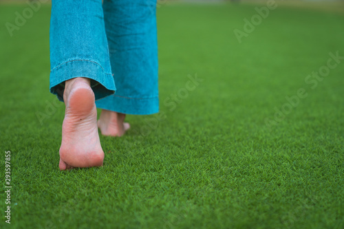 jeans barefoot walking on the grass