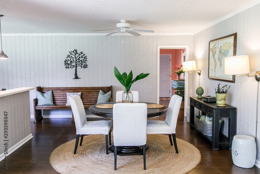 Fototapeta premium Small eat-in kitchen dining room with a small table for four and upholstered chairs