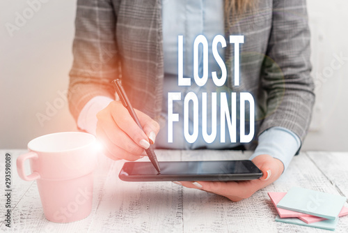 Writing note showing Lost Found. Business concept for Things that are left behind and may retrieve to the owner Business woman sitting with mobile phone and cup of coffee on the table photo