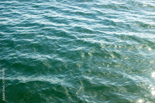 The texture of the water. Sea water in natural light. Background sea wave. Blue Wave.