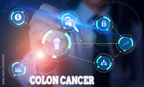 Handwriting text writing Colon Cancer. Conceptual photo the development of cancer cells from the colon or rectum Woman wear formal work suit presenting presentation using smart device