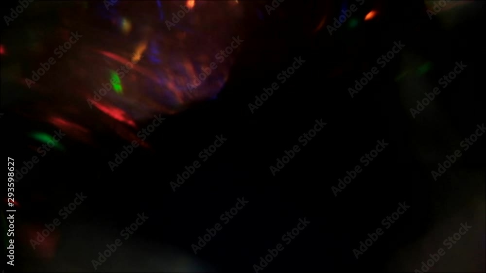Gleam motion overlay. Steam effect. Multicolor glowing lights on black background. Gleam motion overlay. Steam effect. Multicolor glowing lights on black background.