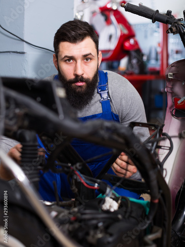 Worker repairing motorbike