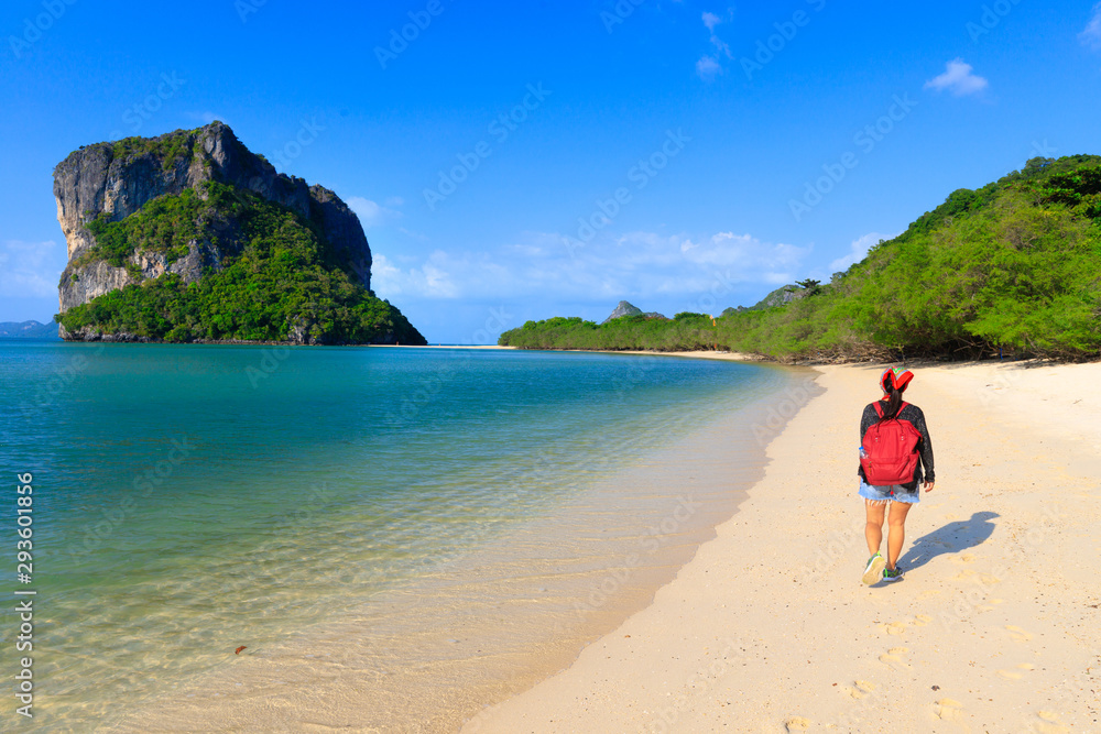 Woman walking on tropical beach