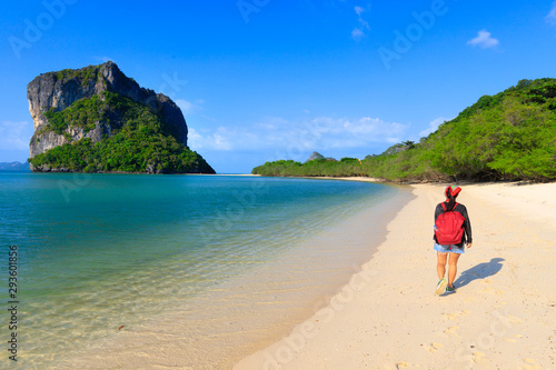 Woman walking on tropical beach