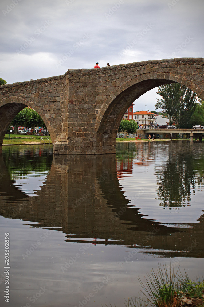 Old stone bridge over river in Spain