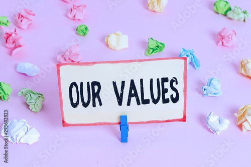 Conceptual hand writing showing Our Values. Concept meaning list of morals companies or individuals commit to do them Colored crumpled papers empty reminder pink floor clothespin © Artur