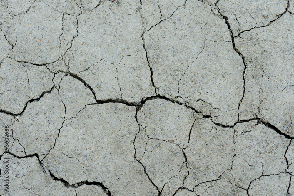 Fototapeta premium White dried and cracked ground. erosion earth background. cracked dry wall surface. white natural cracked texture