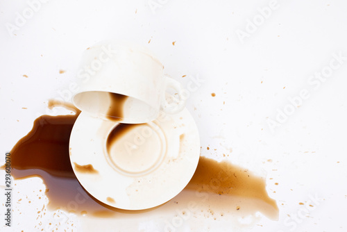 Top view, overturned beverage with spilled coffee on a white background
