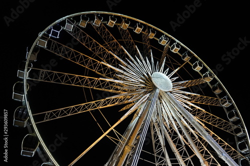 Ferris wheel. A ferris wheel rotates against the background of the night sky. Close-up of a Ferris wheel with night illumination.