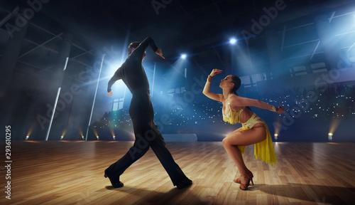 Couple dancers  perform latin dance on large professional stage. Ballroom dancing. © VIAR PRO studio
