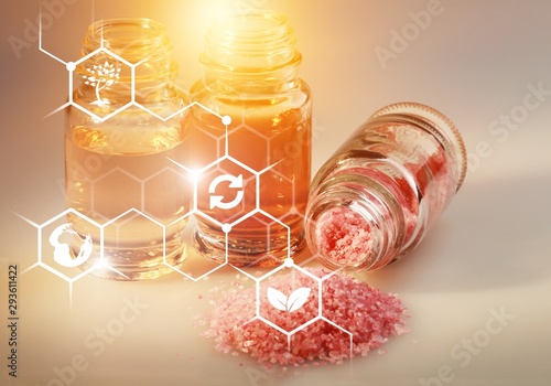 Pile of lavender flowers and a dropper bottle with lavender essence