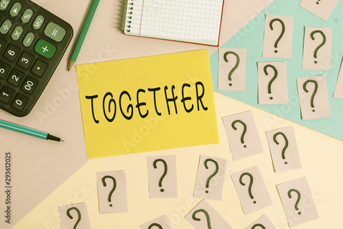 Conceptual hand writing showing Together. Concept meaning In proximity,union or collison with another demonstrating or things Mathematics stuff and writing equipment on pastel background photo