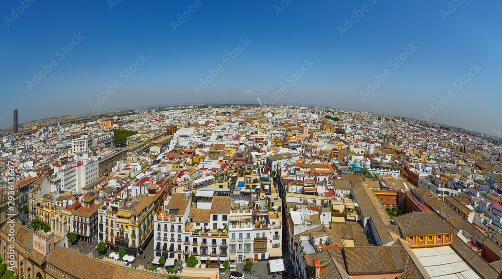 Naklejka premium Panoramic view of Seville from the height of the Giralda tower of Cathedral on a sunny day.