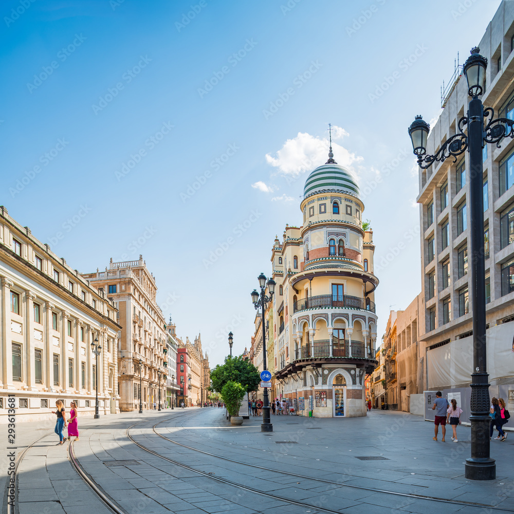 Naklejka premium Constitution Avenue with a view of the Adriatic Building, Cathedral and Archivo de Indias. Panorama. Seville, Andalusia, Spain