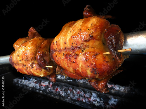 Grilled chickens on fire , whole roasted chicken.