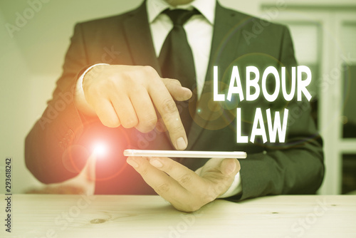 Writing note showing Labour Law. Business concept for Rules implemented by the state between employers and employee