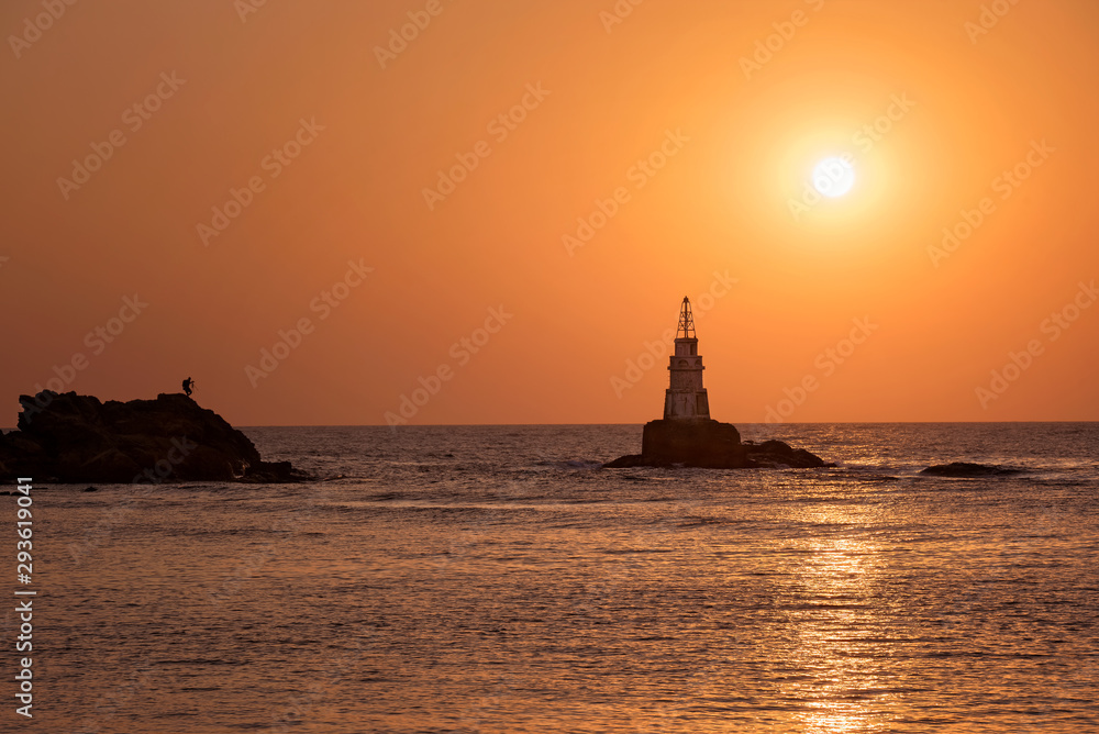 Photographer shooting beautiful sunrise. Landscape from the Black Sea, Bulgaria, Ahtopol lighthouse. Photographer shooting beautiful sunrise. Landscape from the Black Sea, Bulgaria, Ahtopol lighthouse.