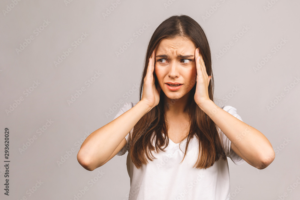 Young beautiful woman over isolated background suffering from headache desperate and stressed because pain and migraine. Hands on head. Young beautiful woman over isolated background suffering from headache desperate and stressed because pain and migraine. Hands on head.