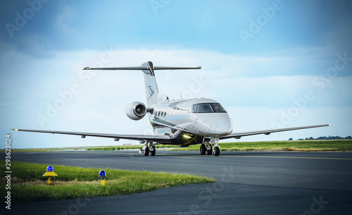 Modern airplane parked on runway. Jet Pilatus on taxiway in Prague.