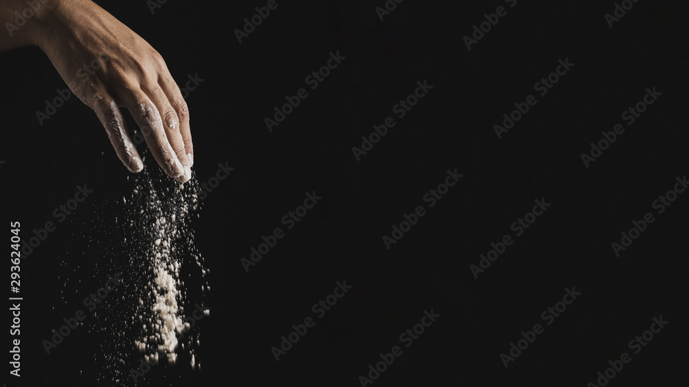 Isolated hand spreading flour with copy space