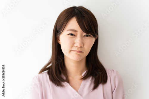 Angry business woman against white background