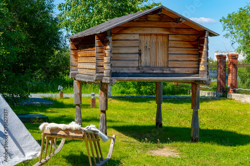 Wooden log warehouse on the logs-legs of the indigenous peoples of Siberia.