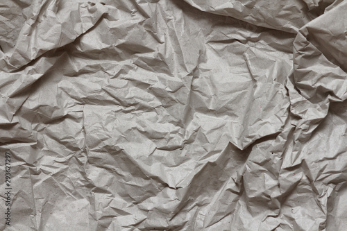 Crumpled gray craft paper texture background. Package wrapping. Old wrapping paper. Baking parchment. Letter template.