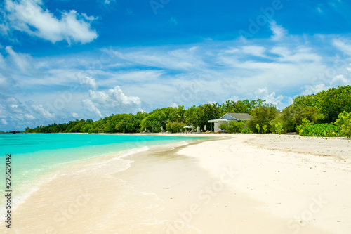 Beautiful sandy beach and over water tropical bungalo