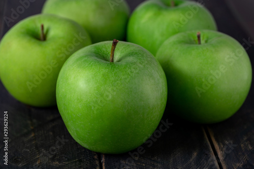 Close up green apple on wooden table background