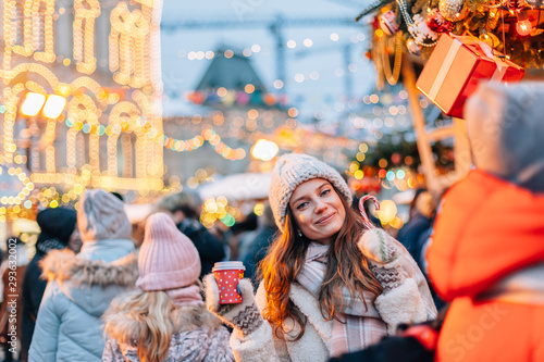 Girl walking on Christmas Market on Red Square in Moscow © Alena Ozerova
