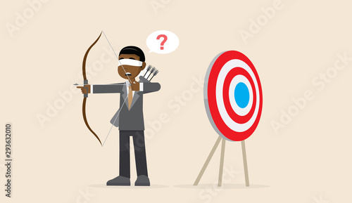 Blindfolded African businessman shooting arrow.