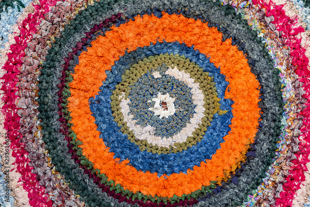 Old handicraft rug made from strips of cloth as background