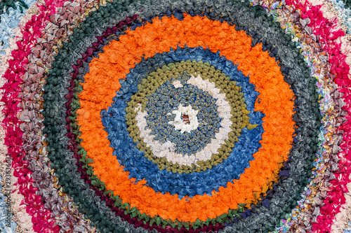 Old handicraft rug made from strips of cloth as background