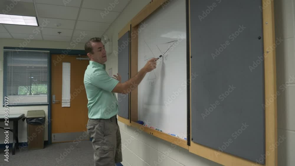 Man teaching, giving a lecture, presentation, standing in front of wall in front of a class, 60fps. Man teaching, giving a lecture, presentation, standing in front of wall in front of a class, 60fps.