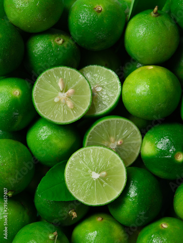 Fresh ripe limes and lime slices as background