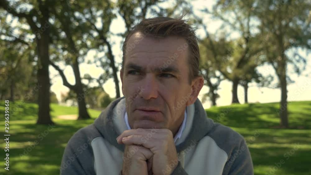 Portrait of a man in park, thinking about life and looking around. Portrait of a man in park, thinking about life and looking around.