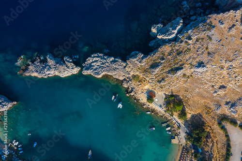 Aerial birds eye view drone photo Saint Paul bay near village Lindos, Rhodes island, Dodecanese, Greece. Sunny panorama with lagoon and clear blue water. Famous tourist destination in South Europe.