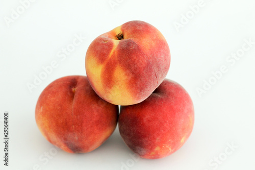three red peaches in white background