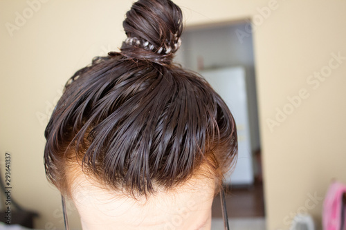 The process of hair care. Hair when applying balm or mask. Hair in a bun photo