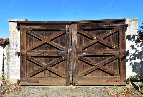 Old countryside wooden gate with with stone columns in vintage style